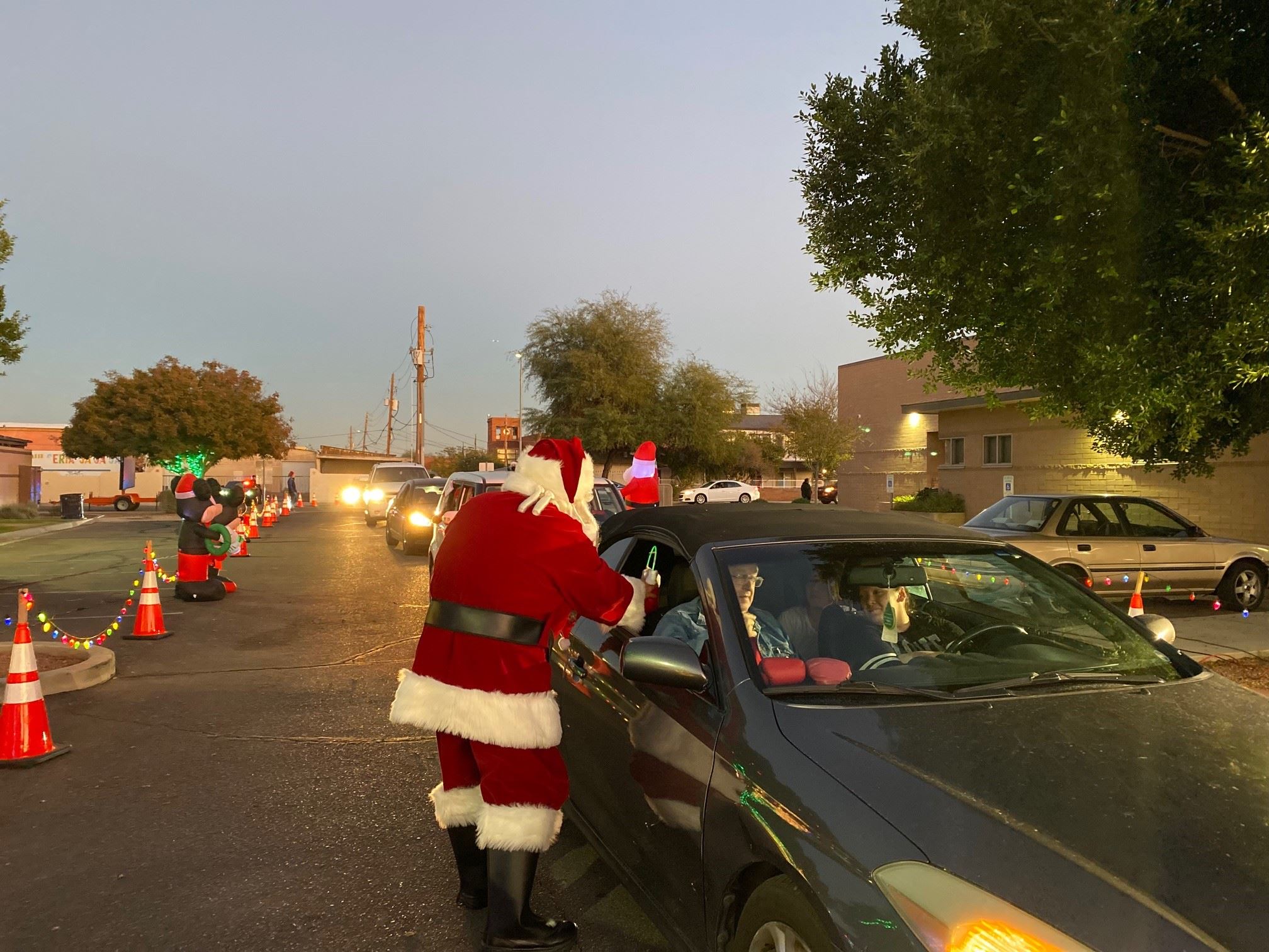 Santa greeting family car
